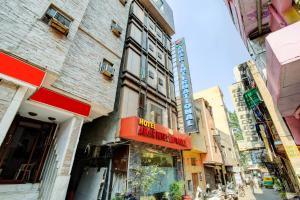 a building with a red sign on the side of a street at Hotel Amar International in New Delhi