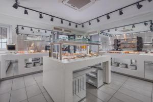 a restaurant kitchen with a buffet of food at Adrina Beach Hotel in Panormos Skopelos