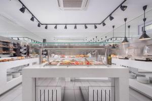 a kitchen with a counter with food on it at Adrina Beach Hotel in Panormos Skopelos