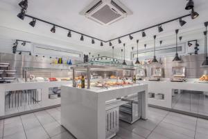 a restaurant kitchen with a buffet of food at Adrina Beach Hotel in Panormos Skopelos