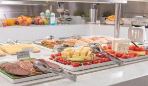 a buffet with meats cheese and other foods on display at Adrina Beach Hotel in Panormos Skopelos