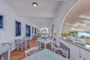 a view of a restaurant with tables and chairs at Adrina Beach Hotel in Panormos Skopelos