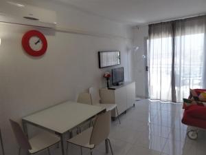 a living room with a dining room table and a red clock at Ocean View in Adeje