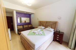 a bedroom with a bed with a towel on it at Mala Plaza in Ulcinj