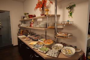 a buffet with plates and bowls of food on a table at Centro Hotel Oberhausen in Oberhausen