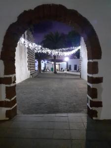 an archway with christmas lights at night at Home From Home in Teguise