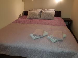 a bedroom with a bed with two towels on it at Ovelia B&B in Kuressaare