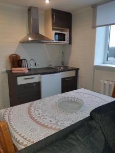 a small kitchen with a table and a sink at Ovelia B&B in Kuressaare