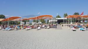 a group of people sitting in chairs on a beach at Alanya Goldcity one bedroom villa in Kargicak