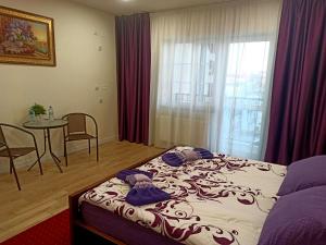 a bedroom with a bed and a table and a window at Palace in Umanʼ