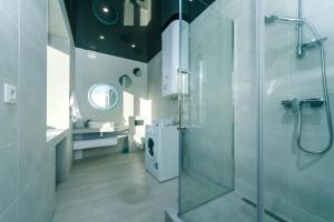 a bathroom with a shower and a washing machine at Pechersky Kvartal Apartments in Kyiv +71 photos