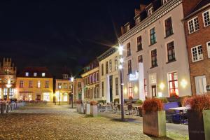 a city street at night with buildings and tables at Haus Seestern in Kalkar
