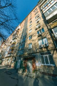 a tall brick building with windows on a street at Pechersky Kvartal Apartments in Kyiv