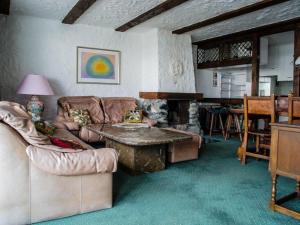 a living room with a couch and a table at Haus Viols 54 in Savognin