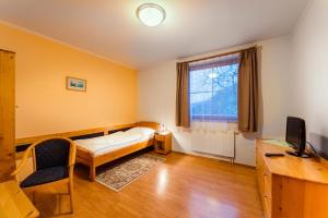 Postel nebo postele na pokoji v ubytování Hotel Velká Klajdovka