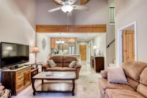 a living room with two couches and a flat screen tv at The Alpine Meadows in Alpine Meadows