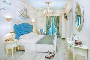 a bedroom with a large bed and a blue headboard at Archontiko Kymis Boutique Hotel in Kymi