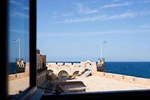 
a view from a balcony overlooking a beach at Alcanea Boutique Hotel in Chania Town
