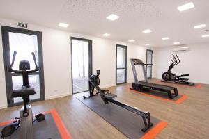 une salle de sport avec plusieurs tapis de course et machines elliptiques dans l'établissement Paese di Lava, Grand Ajaccio, à Alata