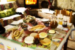 a table with cheese and other food on it at Agriturismo La Cascina in Bossolasco