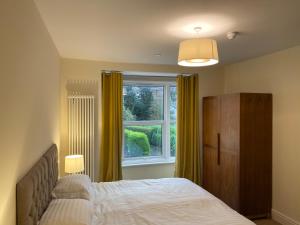 a bedroom with a bed and a window at Regent Retreat, Llangollen - 8 bedrooms, 7 bathrooms, games rooms, Sky TV, parking in Llangollen