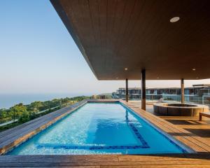 a swimming pool on the roof of a house at No 2 Heleza Blvd Sibaya, Ocean Deuns, Umhlanga Durban in Umdloti