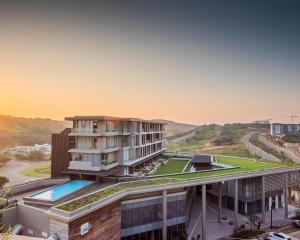 a building with a swimming pool on top of it at No 2 Heleza Blvd Sibaya, Ocean Deuns, Umhlanga Durban in Umdloti