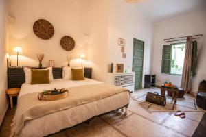 a bedroom with a large bed in a room at Riad Palais Calipau in Marrakech