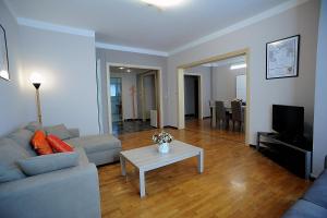 a living room with a couch and a table at Casa Vacanze Helsinore in Sanremo