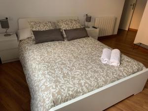 a bedroom with a bed with two slippers on it at Piso Andorra in Andorra la Vella