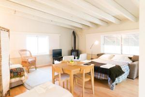 a living room with a bed and a table at Quinta das Leiras in Santo Tirso