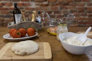 a wooden table with a dough on a cutting board and a bowl of ingredients at Agriturismo Le Baccane in Vinci