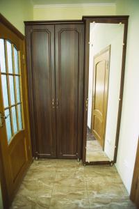 a hallway with two wooden doors in a room at База відпочинку ЕЛЬДОРАДО in Solochyn