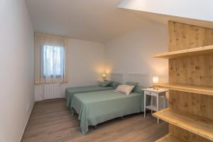 a bedroom with a green bed and a window at Nou Sol Solet in Begur +45 photos
