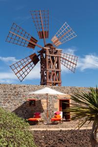 a large windmill sitting on top of a building at La Molina NK in Tindaya