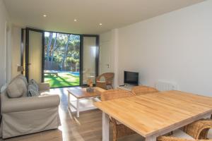 a living room with a wooden table and chairs at Nou Sol Solet in Begur
