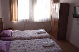 A bed or beds in a room at Emre's Stone House