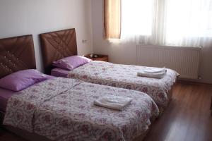 A bed or beds in a room at Emre's Stone House