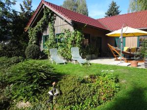 a yard with two chairs and a house at Haus Christine Aigen Schlägl - Adalbert Stifter in Aigen im Mühlkreis