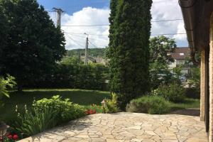 a garden with a large tree and a stone walkway at Balaton Charm Cottage, Your House in Balatonfüred in Balatonfüred