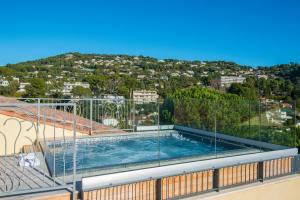 a swimming pool on the balcony of a house at La Bastide de l'Oliveraie in Cannes