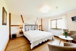 a bedroom with a bed and a table and chairs at Hotel Montfort-Schlössle in Lindau