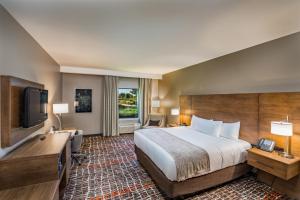 a hotel room with a bed and a flat screen tv at Choctaw Casino Hotel - Grant in Grant