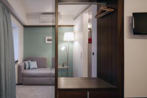 a living room with a couch and a sliding glass door at Stern am Rathaus in Cologne