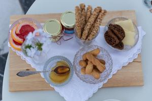 a table topped with plates of food and drinks at CAMARA SUITES in Andros