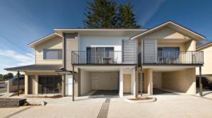 a large house with a balcony on a driveway at Cardiff Executive Apartments in Newcastle