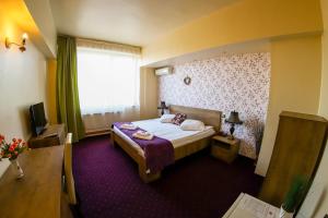 Voodi või voodid majutusasutuse Hotel Olimp toas