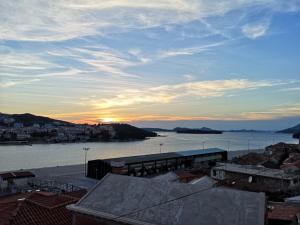 a view of the ocean with the sunset in the background at Nostromo Guesthouse with the Sea View in Dubrovnik