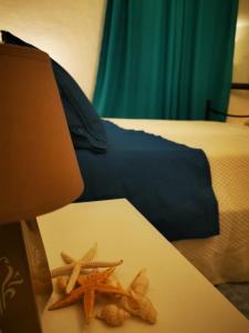 
a person laying on a bed next to a pile of food at Casa Martina in Pula
