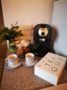 a counter with two cups of coffee and a coffee maker at Casa Martina in Pula